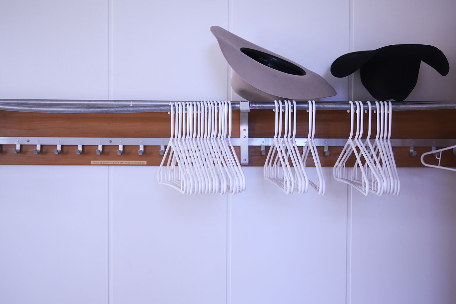 Cowboy hats set atop the coat rack